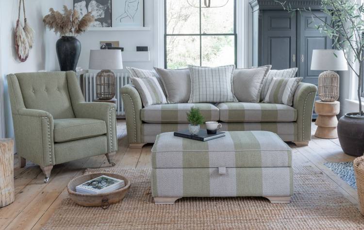 Ottoman shown in a room setting with accent chair & pillow back sofa 