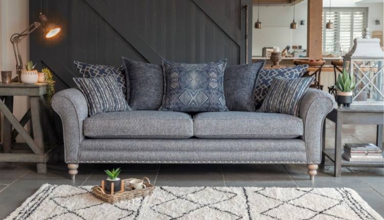 Pictured in fabric 2822 (Band B), 2 pillows in 2132, 2 pillows in 2912, 1 pillow in 2362, small scatter cushions in 2272, grey ash/brushed nickel legs. Item shown with optional pewter studding.