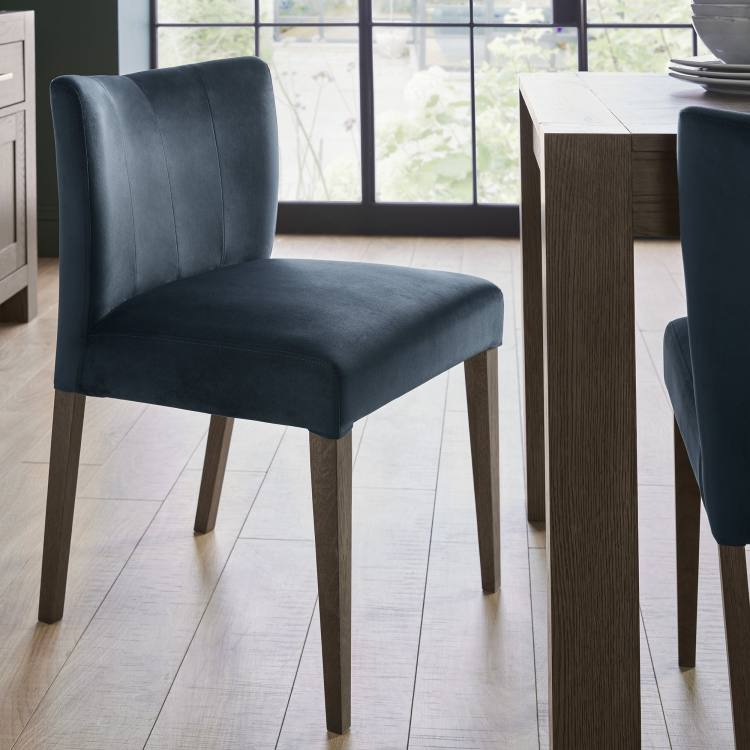 The Bentley Designs Turin Dark Oak Low Back Uph Chair in Dark Blue Velvet on Display